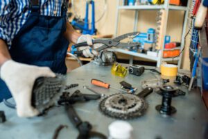 mechanic working on bicycle parts in workshop