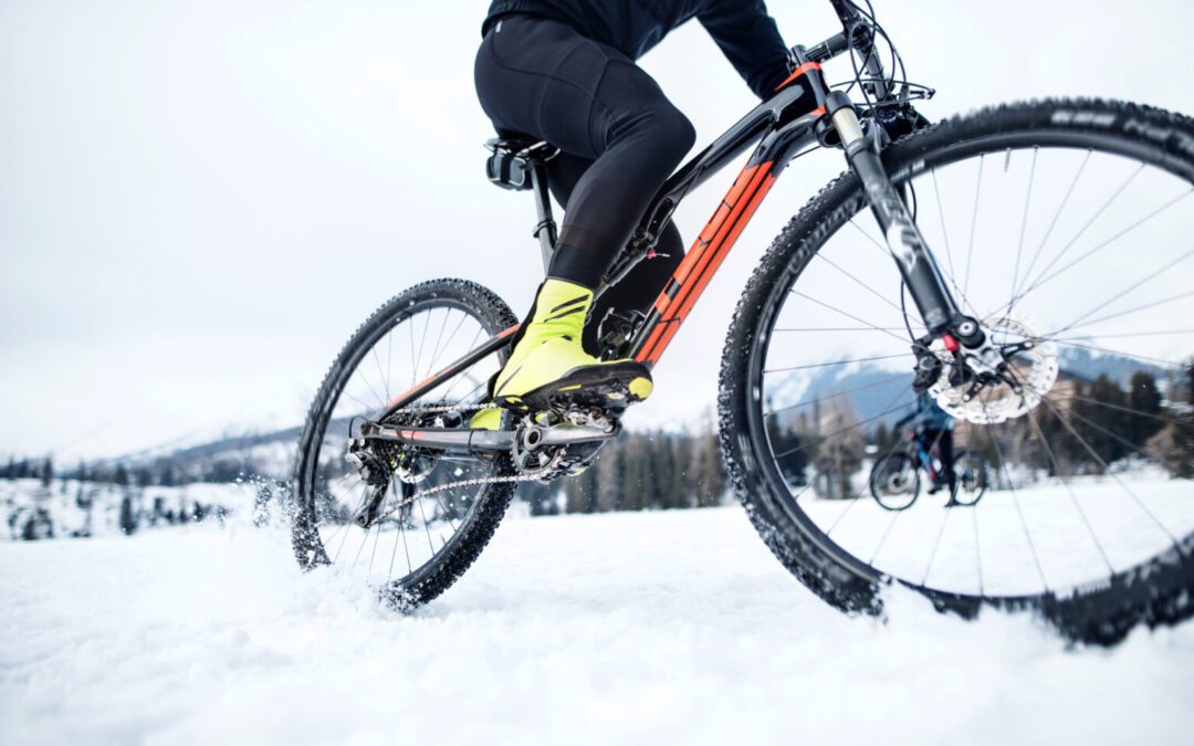 a person riding a mountain bike in the snow