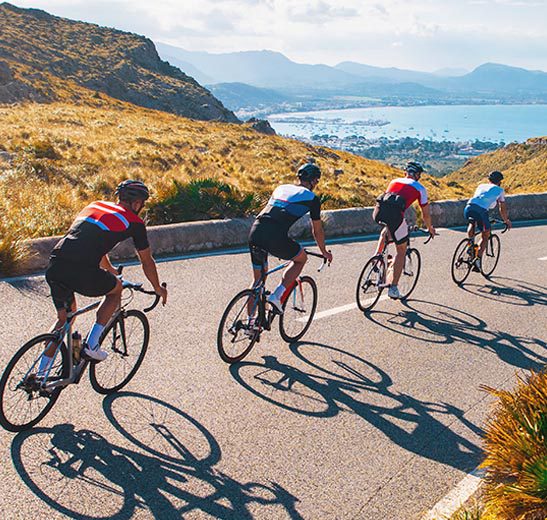 cyclists riding down a mountain road