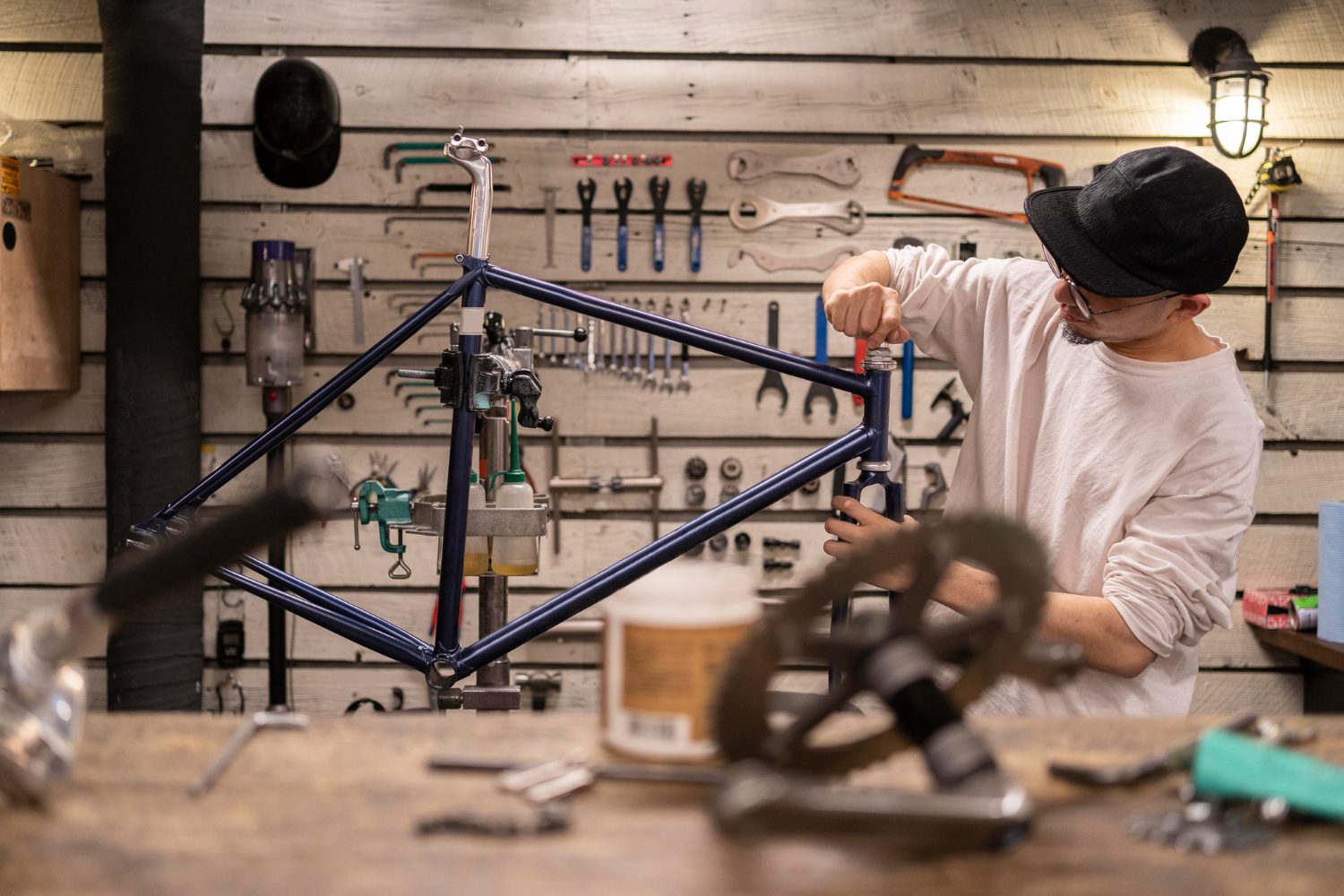 medium shot man repairing bike